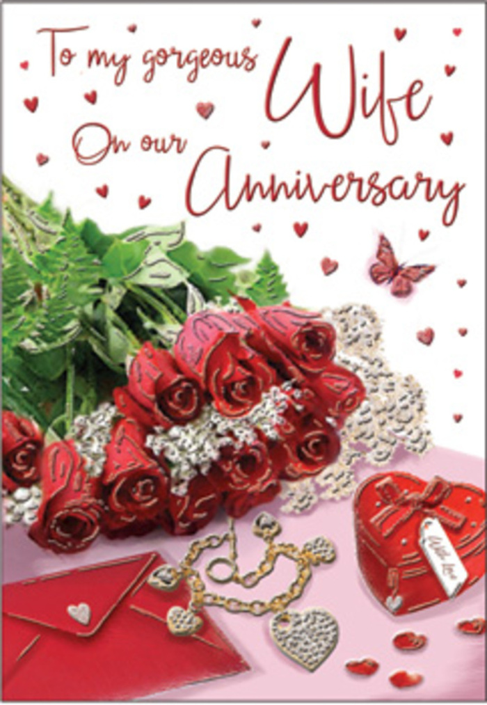 In this richly detailed anniversary card image, a bouquet of classic red roses takes centre stage, their blooms arranged as if by a careful hand in a Herne Hill flower studio. Each rose is fully open, displaying tightly layered petals in shades of deep crimson and soft scarlet that seem to glow against the muted background. Around the blooms, lush green foliage curves and overlaps, giving the arrangement fullness and a sense of living movement, reminiscent of the sweeping greenery that frames nearby Brockwell Park. Just beside the bouquet sits a vivid red heart-shaped box, its surface smooth and gently reflective, hinting at a treasured piece of jewellery or keepsake hidden within. A delicate set of jewellery, likely a fine necklace and perhaps matching earrings or bracelet, lies artfully draped along the card's lower edge, the metal catching small points of light that sparkle like memories shared over many years. Tiny heart motifs and jewelled accents are sprinkled generously across the surface, some lying closer to the roses, others clustered near the writing, like confetti after a joyful celebration. A graceful butterfly figure appears to hover near the blooms, adding a touch of whimsy and the suggestion of love continually renewing itself. The card's text, written in a flowing, romantic script, seems to float among the cascade of red hearts and gentle background tones of blush and rose. Bathed in soft, flattering light, the whole scene feels intimate and timeless, as though composed to mark an anniversary evening spent together in Herne Hill, looking back with gratitude and forward with quiet hope.