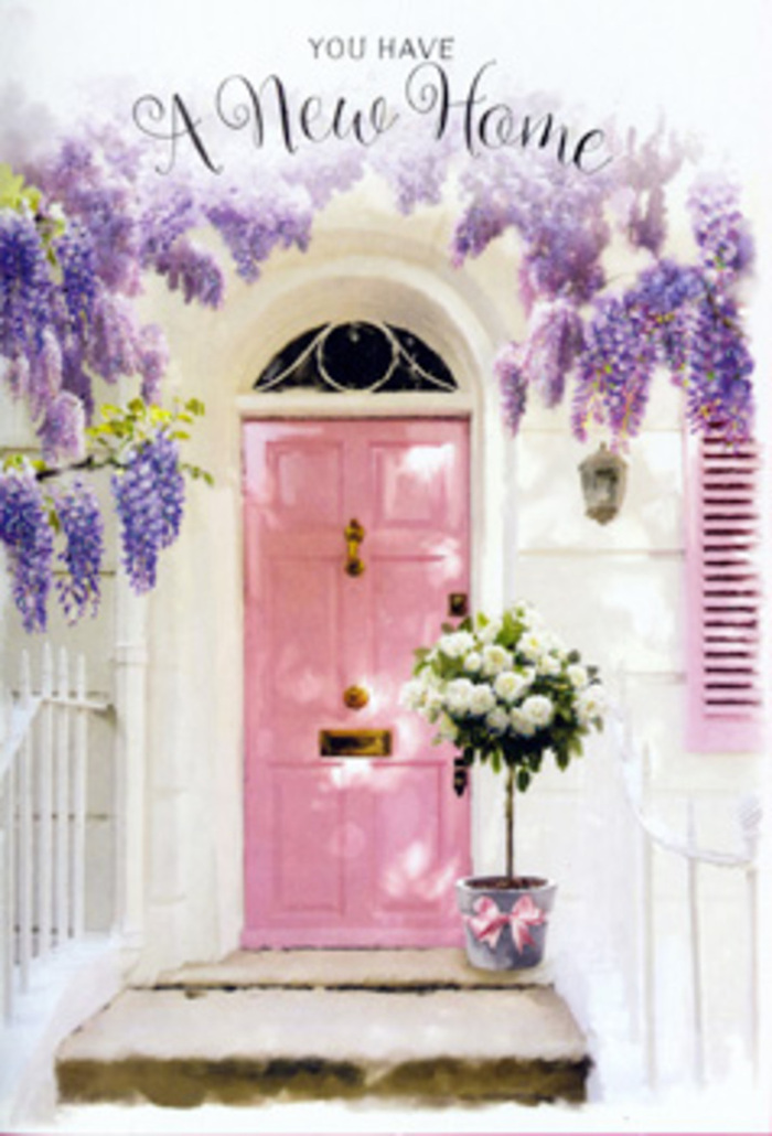 In this evocative Herne Hill doorway scene, a pale pink front door becomes the heart of a gentle celebration, framed by lavish wisteria cascading in lavender curtains from above. The blossoms hang in strands of clustered petals, creating a soft, romantic canopy that might remind you of leafy walks along Railton Road in full spring bloom. The door itself, painted in a warm, comforting blush, sits against whitewashed walls whose slightly uneven surface catches the light in a way that hints at age and character. A matching pastel shutter completes the frame, echoing the door's tone and contributing to a calm, cohesive palette of pink, white, and soft purple. Sunlight, likely filtered through nearby trees, plays quietly across this façade, leaving delicate shadows that bring depth without diminishing the sense of stillness. At the threshold stands a grey metal bucket that looks as if it has just been set down by a skilled local florist. Inside, a generous arrangement of white and cream roses rises in a lush, rounded mound, each bloom full and velvety, with petals opening outward as if breathing in the daylight. Sprigs of fresh green foliage weave through the roses, adding gentle contrast and a sense of movement. Around the base of the bucket, a satin pink ribbon is fastened in a soft bow, its sheen catching stray shafts of light and echoing the door's blush. The overall effect is one of quiet optimism and homely charm, as though this Herne Hill doorway is taking its first breath as a new home, perfectly suited to a housewarming gift offered with love and thoughtful care.