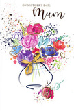 On this Mother's Day card, a lively watercolour bouquet seems to bloom right off the page, much like a freshly gathered arrangement brought home from a Herne Hill florist. Bold cerise and bright pink flowers form the core of the composition, their petals rendered in soft, rounded strokes that bleed gently into one another, giving the feeling of freshly opened blossoms. Deep indigo lines trace portions of the petals and stems, adding subtle definition and a sense of depth, while cooler blue and lavender blooms weave between the warmer tones, calming the palette. Iridescent touches of gold glint along selected petals and leaves, reminiscent of sunlight catching condensation on a vase set near a Brockwell Park-facing window. The bouquet emerges from a simple curved vase shape painted at the bottom, its contours suggested through layered washes of colour and completed with a delicate golden bow that recalls the final flourish of ribbon on a hand-tied gift. Around the arrangement, light-hearted splashes of colour, tiny dots, and scattered heart motifs float against a crisp white background, like petals mid-air during a moment of joyous celebration. The spacing of the elements keeps the design open and airy, echoing the relaxed feel of Herne Hill's leafy streets. Each brushstroke conveys both spontaneity and affection, as if the artist painted with a beloved mum firmly in mind. The card becomes a lasting floral gesture on paper, ideal for expressing gratitude, love, and a sense of home to mothers who cherish both flowers and heartfelt words.